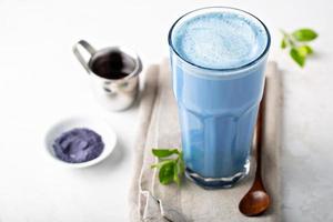 Blue matcha latte in tall glass photo
