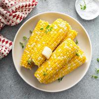 Cooked corn on the cob with salt and butter photo