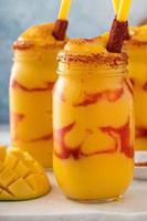 Mangonada mexican mango smoothie with chamoy sauce and lime seasoning photo