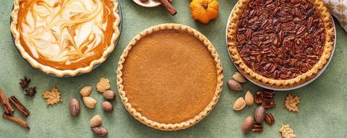 Traditional fall Thanksgiving pies, pumpkin and pecan pie photo