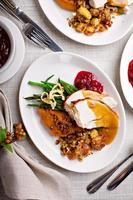 Festive Thankgiving dinner table with plates of food photo