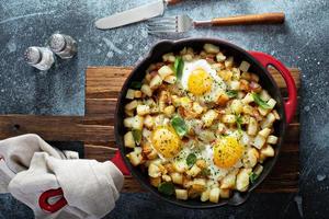 Potato hash with ham and eggs photo