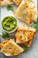 Shrimp and cheese quesadillas served with guacamole photo