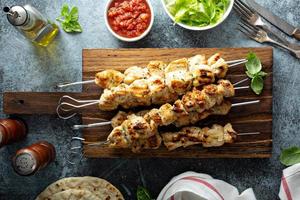 Chicken kebabs on a board photo