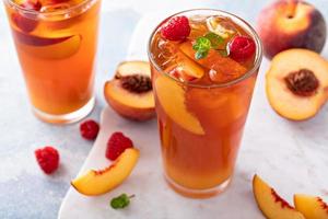 Peach and raspberry iced tea or cocktail photo