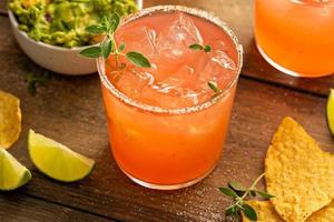 Spicy grapefruit margarita with chips and guacamole photo