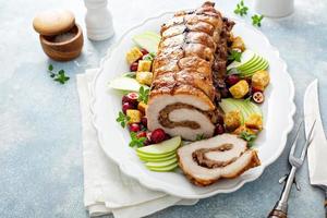 Roasted pork loin stuffed with apple and cranberry filling photo