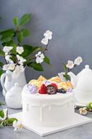 Vanilla cake for Mother's day with flowers and white chocolate glaze photo