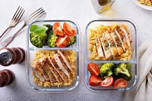 Healthy meal prep containers with chicken and rice photo