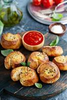 Garlic dinner rolls with marinara sauce photo