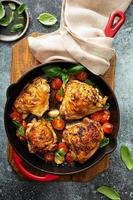 Chicken thighs roasted with tomatoes and garlic photo