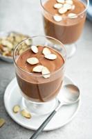 Chocolate pudding with sliced almonds photo