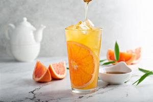 Grapefruit honey jasmine tea served cold with ice photo