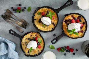 Berry crumble baked in small cast iron pans photo