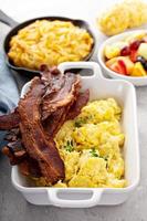 Full breakfast with scrambled eggs, bacon and potatoes photo