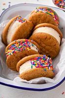 Ice cream and cookies sandwiches stacked on the table photo