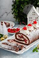 Black forest cake roll with whipped cream and cherries photo