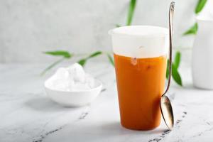 Refreshing mango drink topped with creamy topping photo