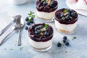 Blueberry cheesecake in a jar with graham cracker base photo