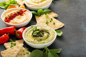 Hummus board with pita and different kinds of hummus photo