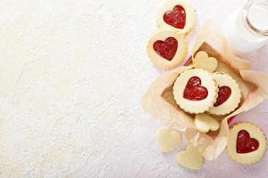 Heart shaped vanilla cookies with jam filling photo