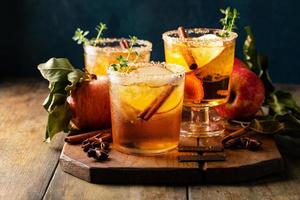 Apple cider margarita with brown sugar rim and cinnamon stick photo