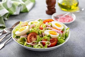 Spring vegetable salad with boiled eggs photo