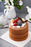 Chocolate cake for Mother's day with berries and chocolate topping photo