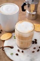 Hot coffee latte and cappuchino in a glass and mug photo