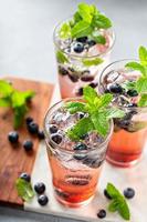 Blueberry mojito in tall glasses with mint photo