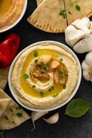 Roasted garlic hummus topped with olive oil photo