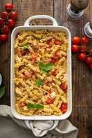 Baked feta pasta with cherry tomatoes and herbs photo