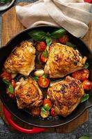 Chicken thighs roasted with tomatoes and garlic photo