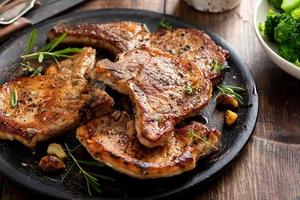 Grilled or pan fried pork chops on the bone photo