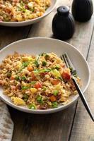 Breakfast fried rice with bacon and scrambled eggs photo