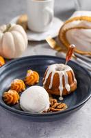 Pumpkin bundt cake soaked with rum served with ice cream photo