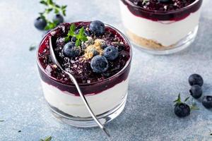 Blueberry cheesecake in a jar with graham cracker base photo