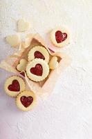 Heart shaped vanilla cookies with jam filling photo