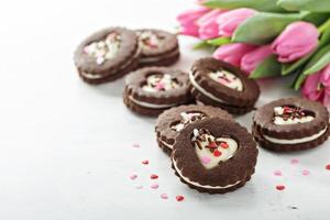 Heart shaped chocolate cookies with cream filling photo