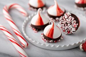 Peppermint meringue kisses dipped in dark chocolate photo