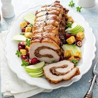 Roasted pork loin stuffed with apple and cranberry filling photo