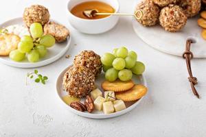 Cheese balls or truffles on a cheese board with crackers photo