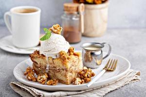 Apple bread pudding with caramel sauce and ice cream photo