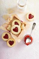 Heart shaped vanilla cookies with jam filling photo