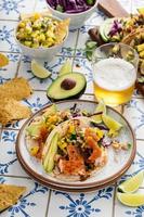 Fish tacos with mango salsa and red cabbage photo