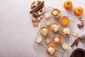 Mini pumpkin pies with wipped cream and cinnamon photo