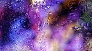 Purple Neon Blurred Lights Through Glass Window With Raindrops On It in Karachi Pakistan 2022 photo