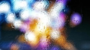 Purple Neon Blurred Lights Through Glass Window With Raindrops On It in Karachi Pakistan 2022 photo