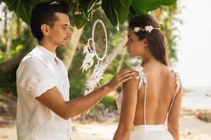 Just married couple is celebrating their wedding on the beach photo