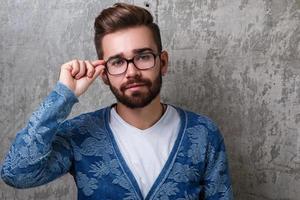 Handsome young bearded man wearing the eyeglasses photo